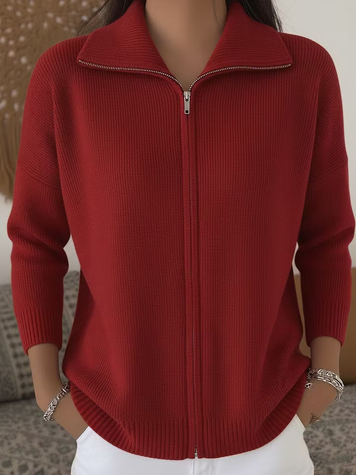 Red zip-up sweater worn by a person with a neutral background