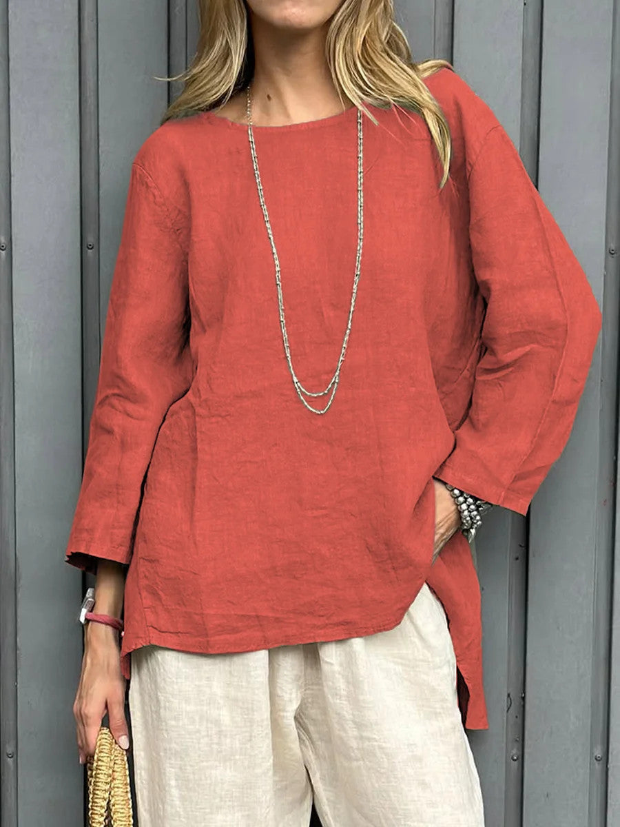 Person wearing a red top and white pants against a gray background