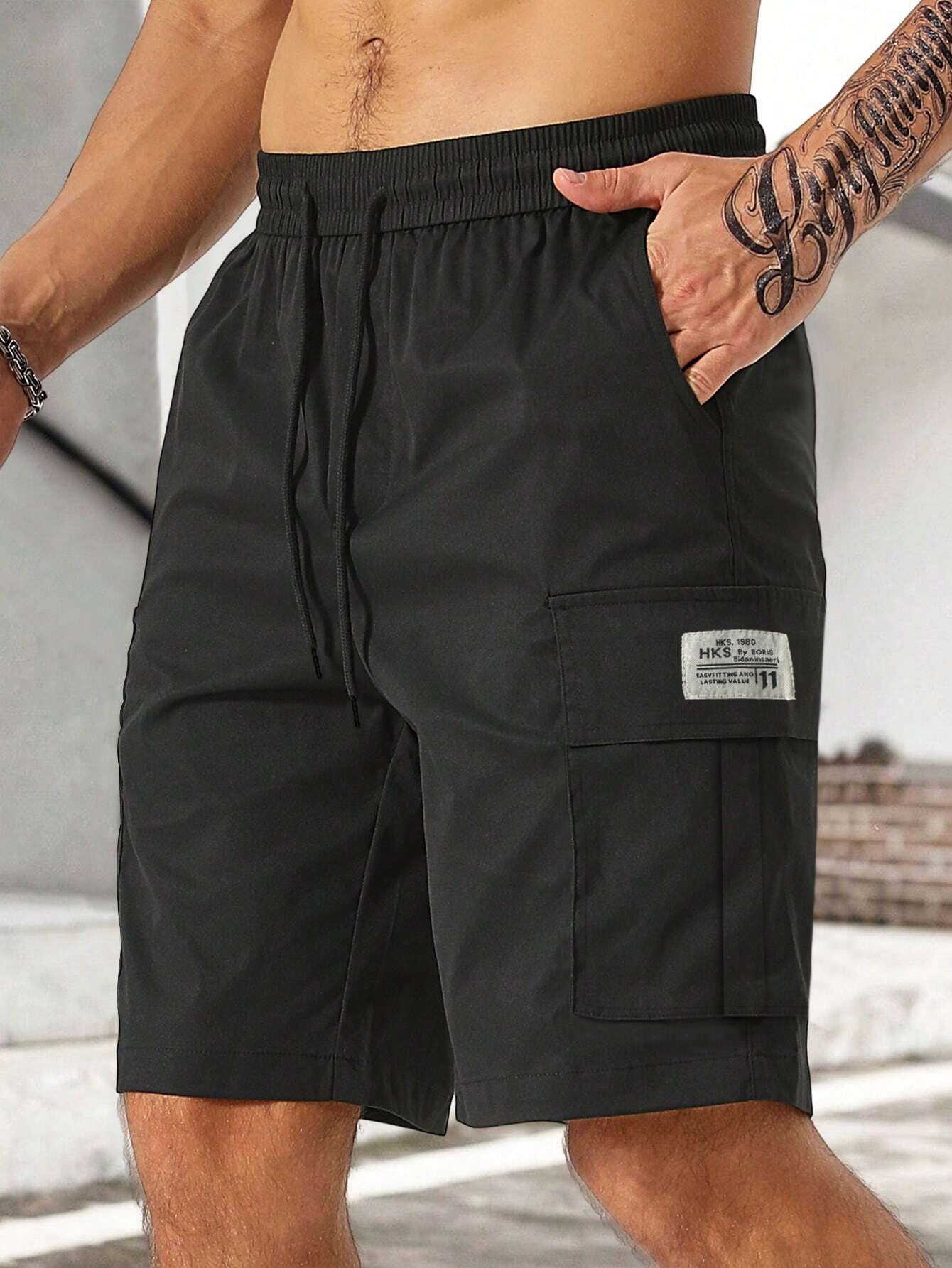 Black cargo shorts with a visible brand label on a neutral background