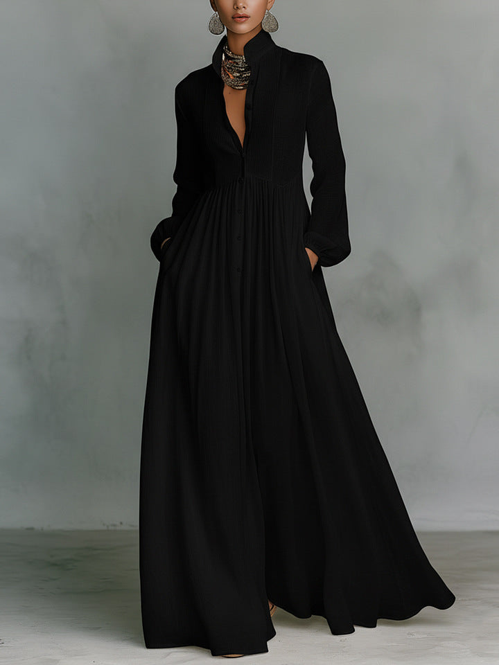 Black long dress worn by a model against a gray background