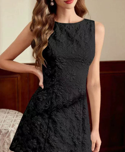 Black lace dress worn by a model with a neutral background