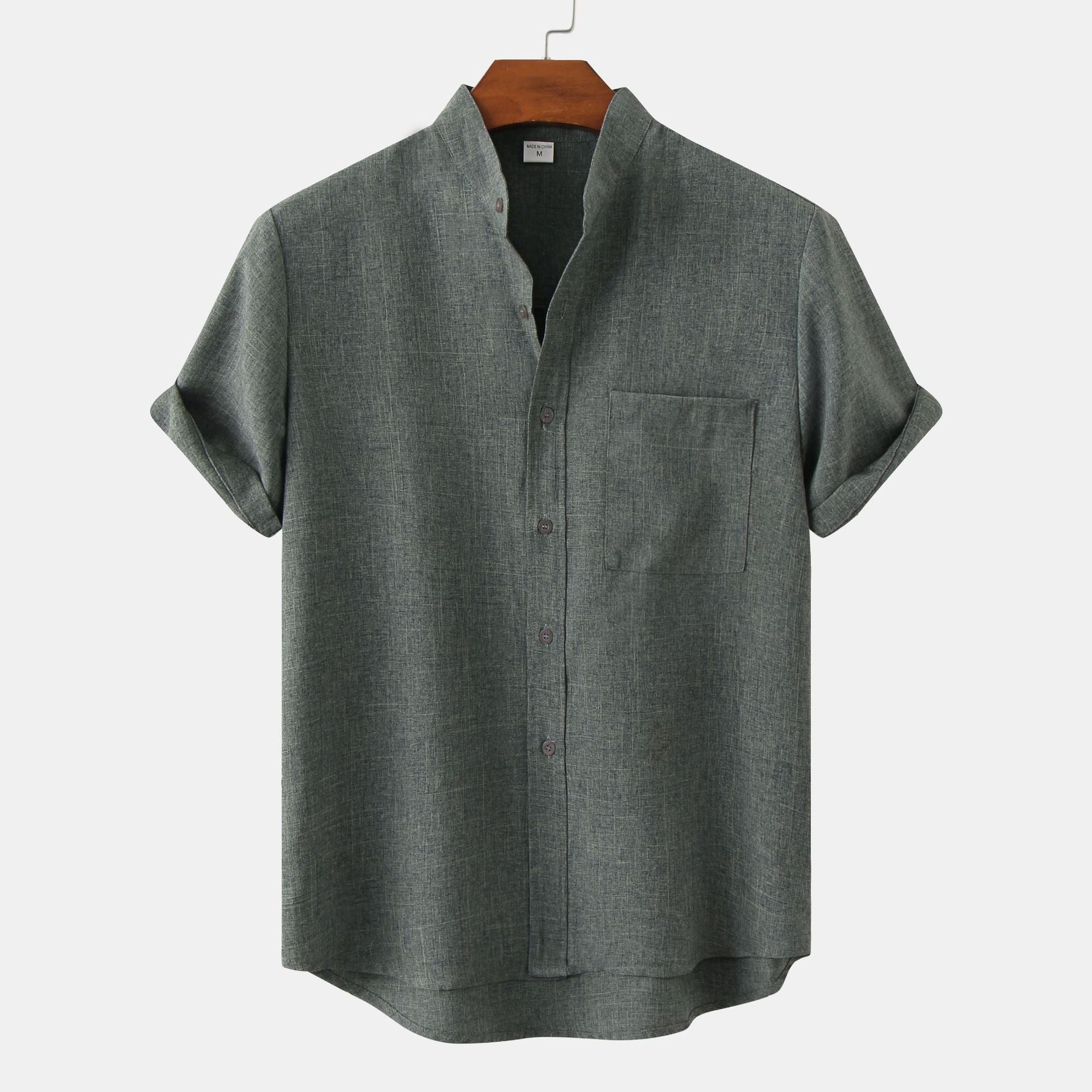 Gray short-sleeve shirt on a hanger against a white background