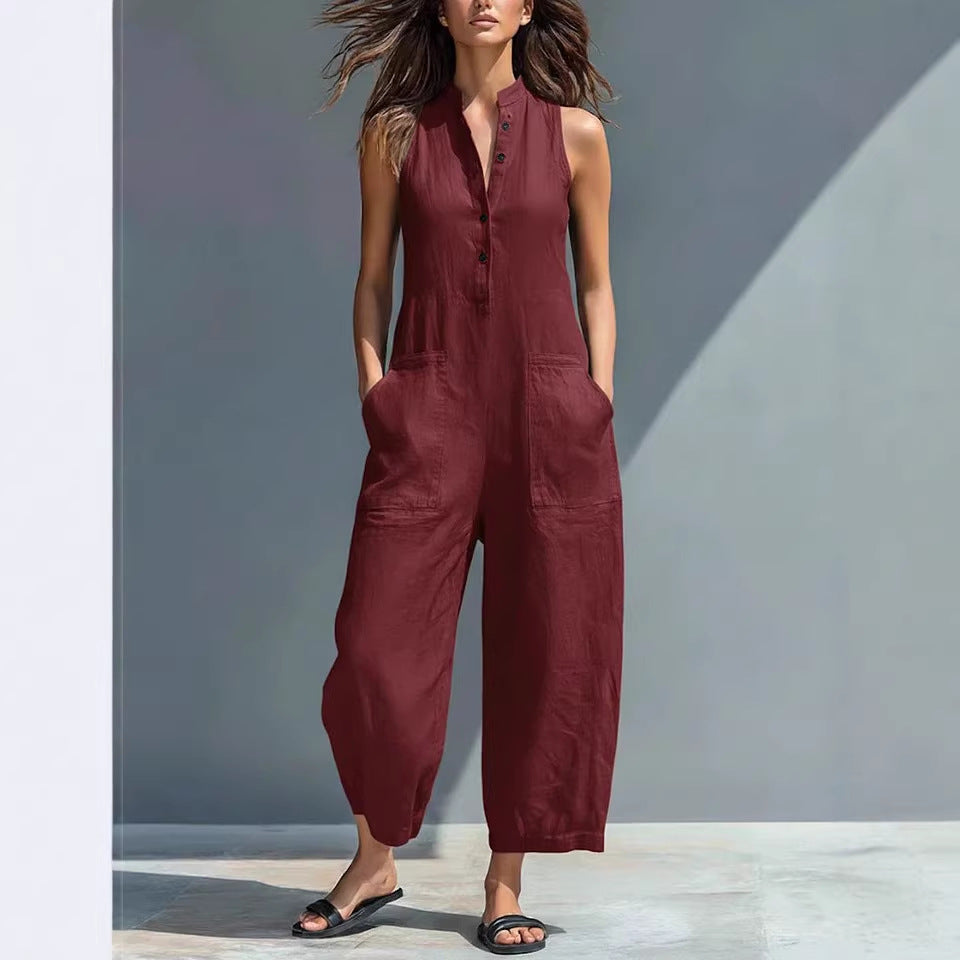 Woman wearing a maroon jumpsuit against a gray background