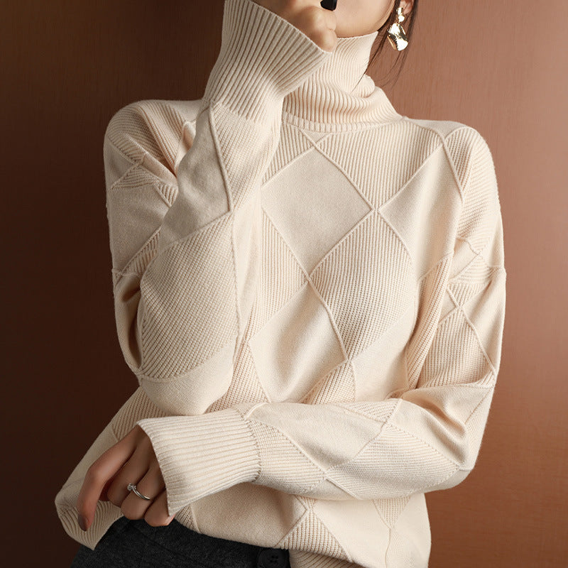 Beige turtleneck sweater with diamond pattern on a brown background