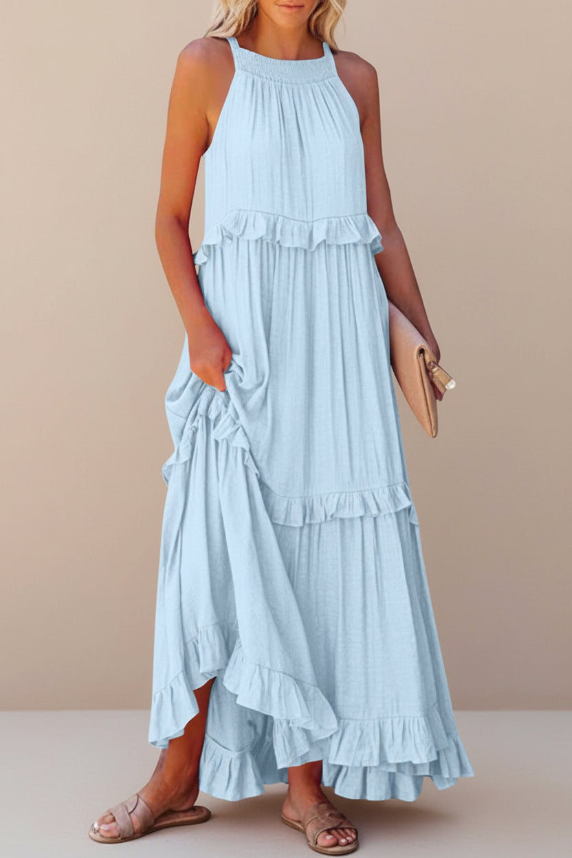 Woman wearing a light blue tiered dress on a white background