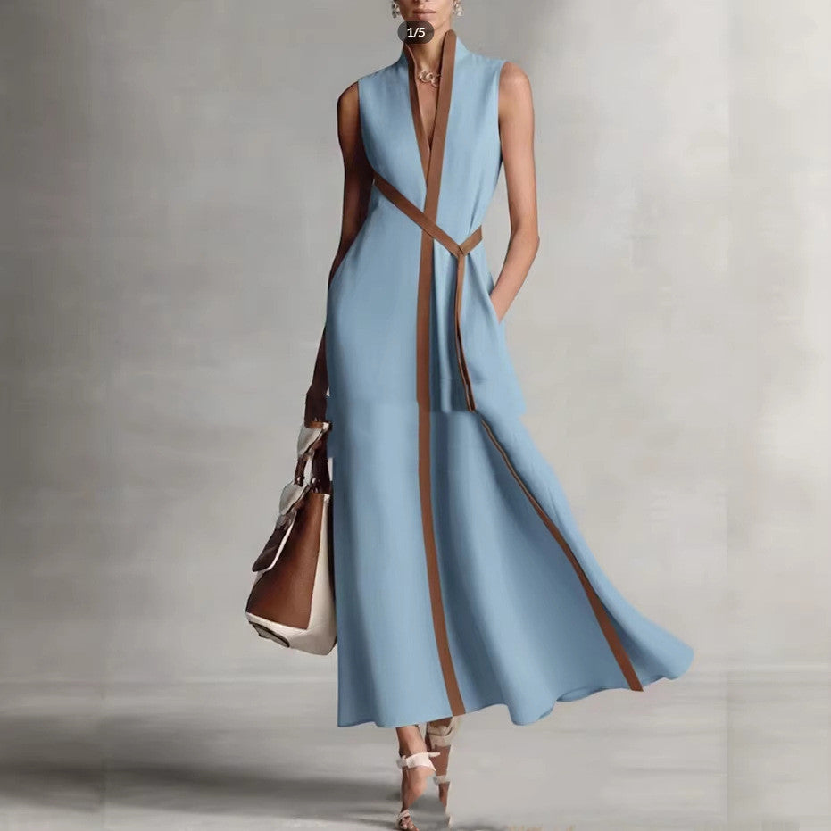 Woman wearing a blue dress with brown accents on a gray background