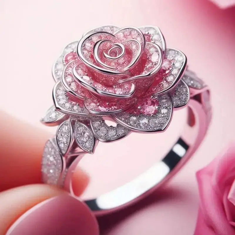 Pink rose-shaped ring with gemstones on a pink background