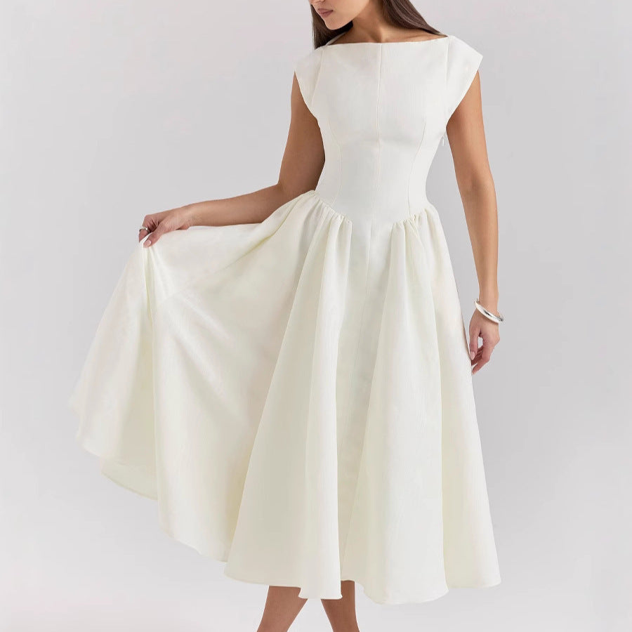 Woman wearing a white dress on a plain background