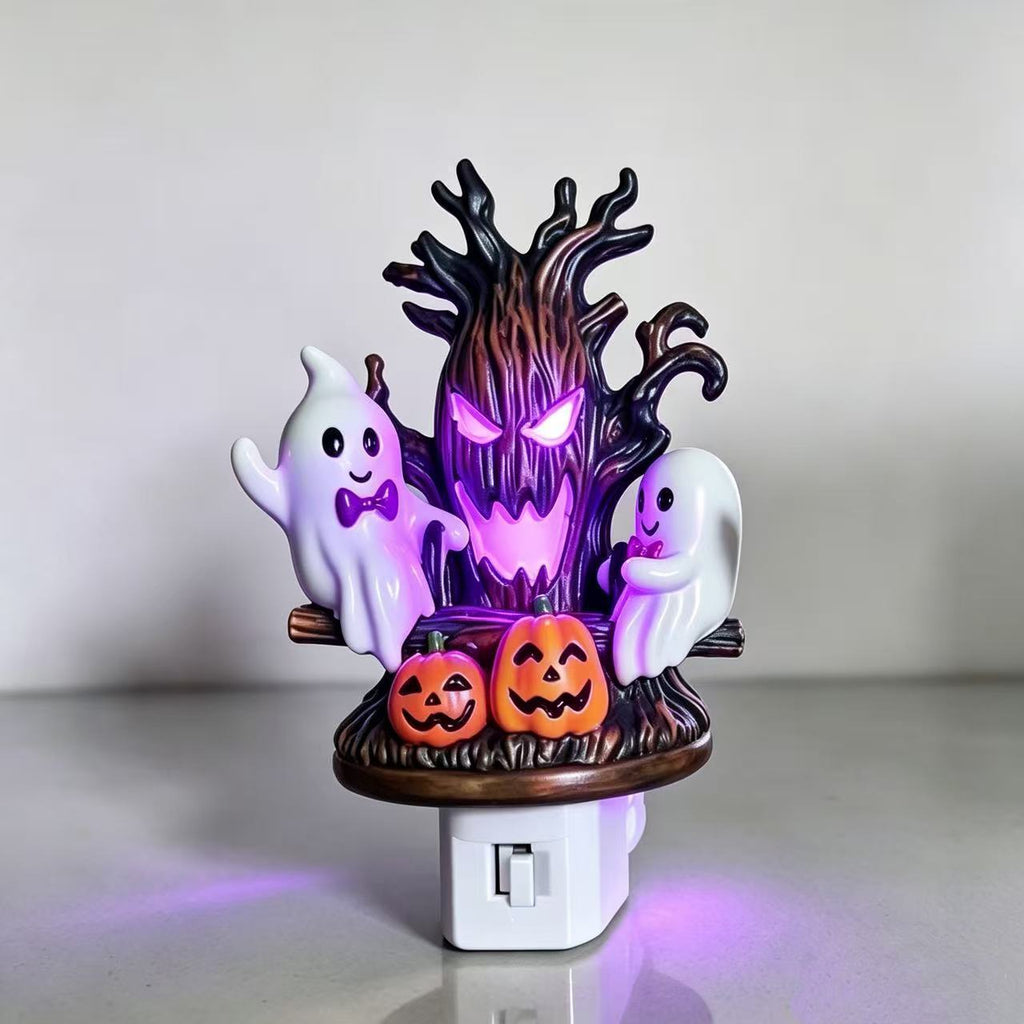 Halloween night light featuring a glowing purple tree stump, two white ghosts, and two orange jack-o'-lantern pumpkins on a white switch outlet base.