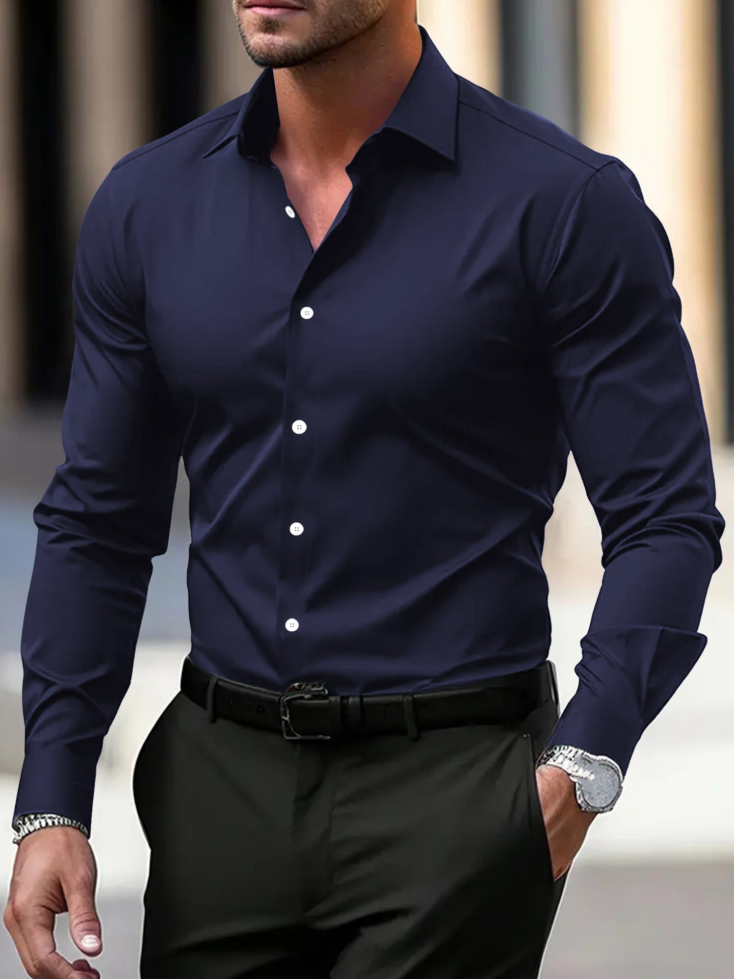 Man wearing a navy blue dress shirt with white buttons and black pants.
