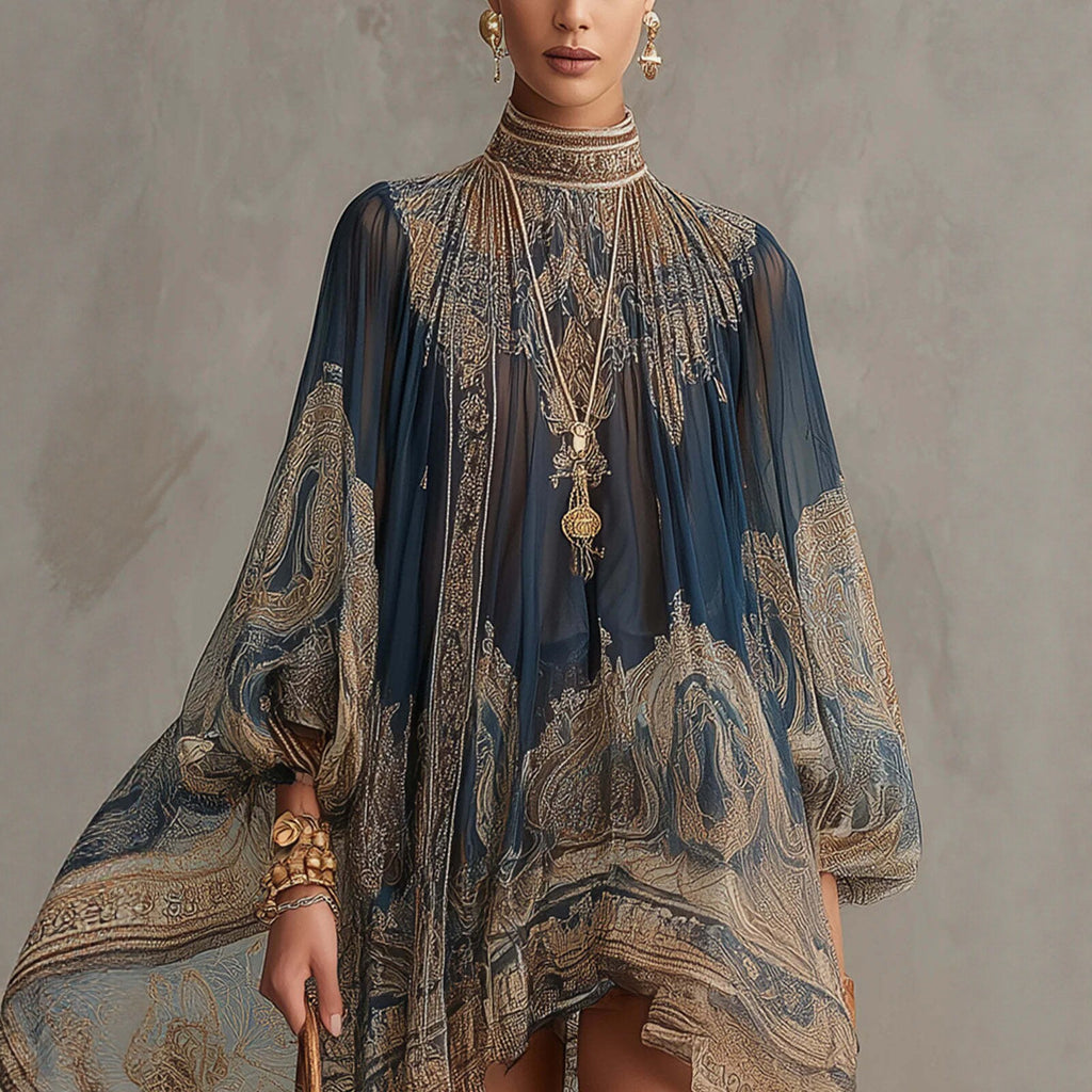Woman wearing a luxurious, patterned garment with intricate designs against a neutral background