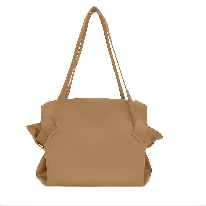 Brown handbag with ruffled details on a white background