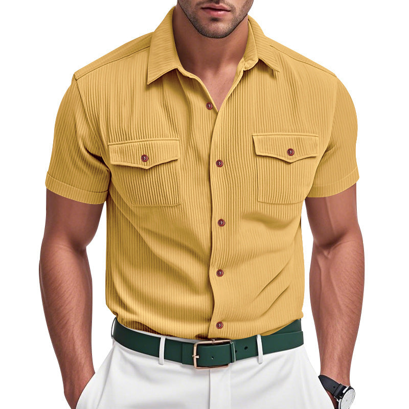 Man wearing a mustard yellow short-sleeve shirt with a white background