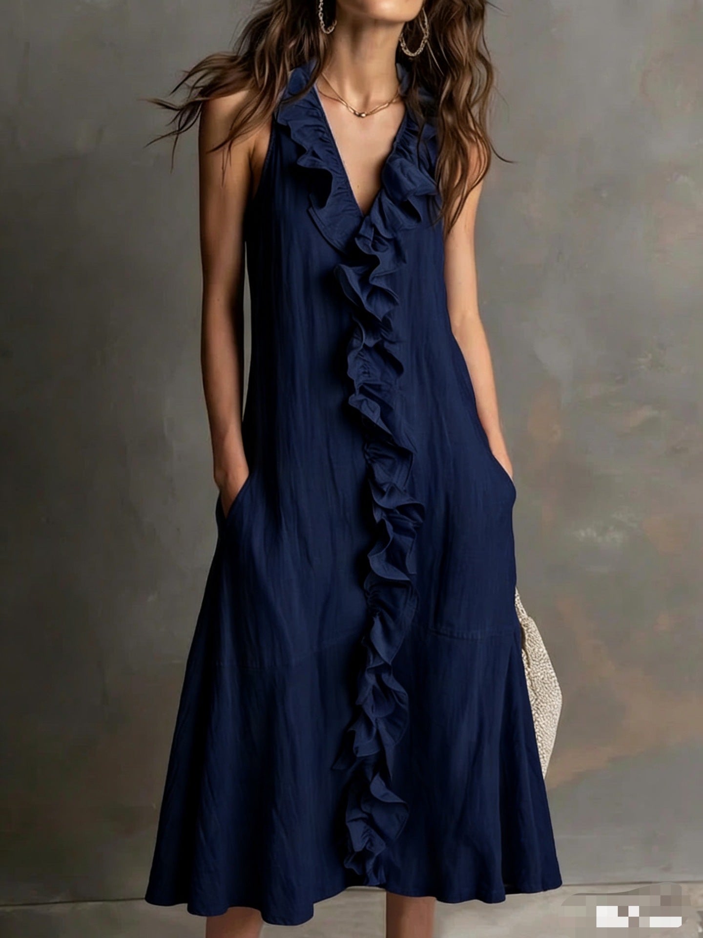 Navy blue ruffled dress worn by a model against a neutral background