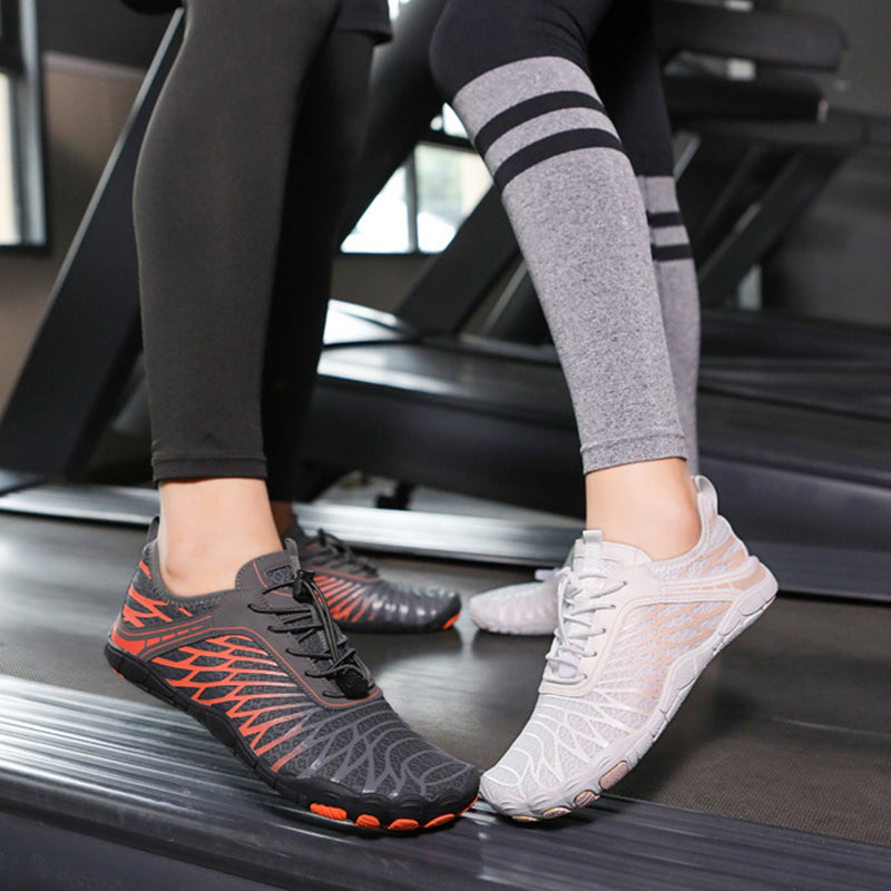 Person wearing black and orange athletic shoes and white sneakers on a treadmill.
