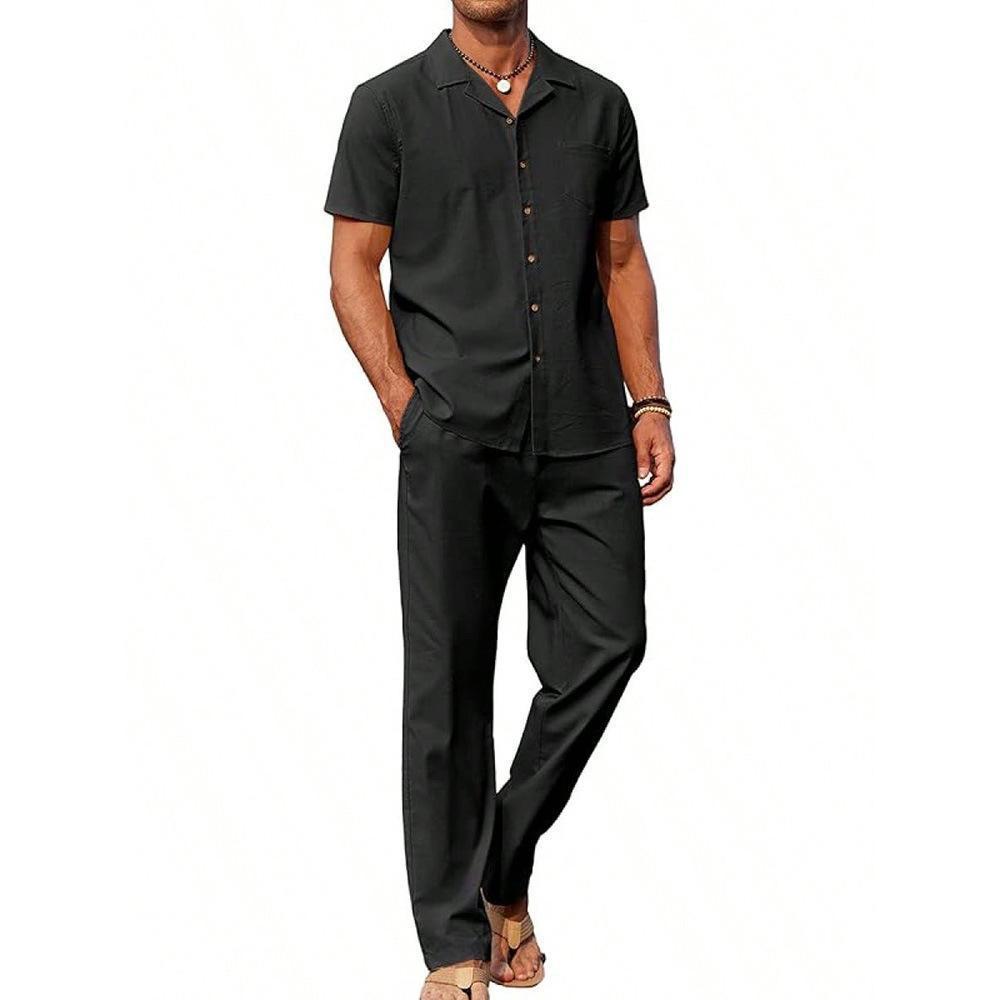 Man wearing a black short-sleeve shirt and pants on a white background