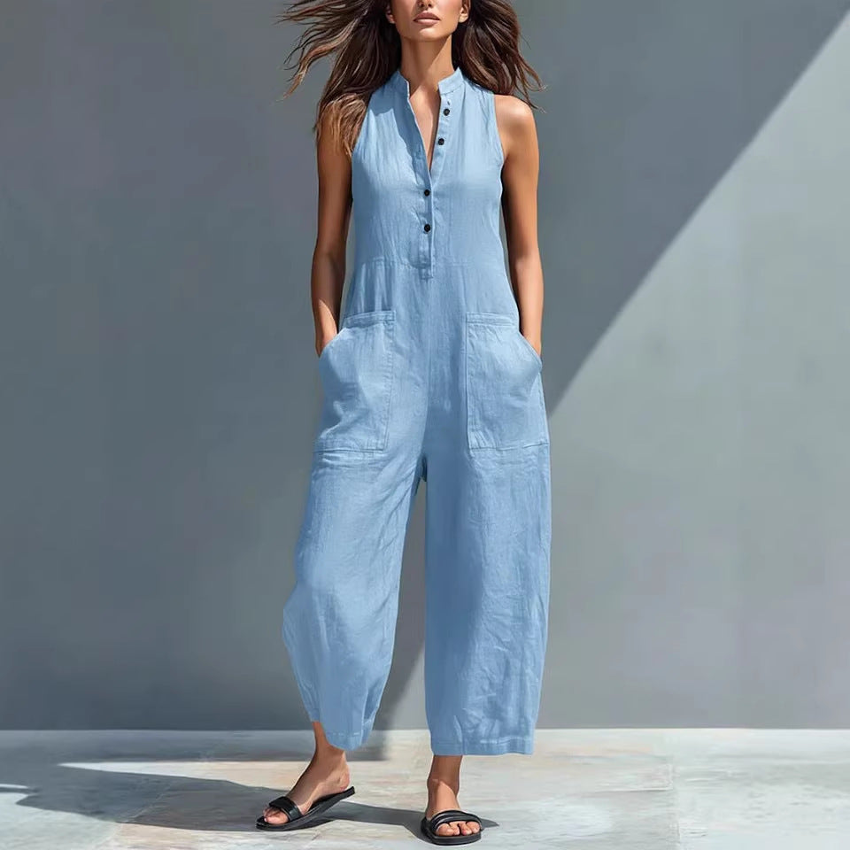 Woman wearing a light blue jumpsuit against a gray background