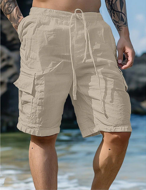 Beige cargo shorts worn by a person on a beach.