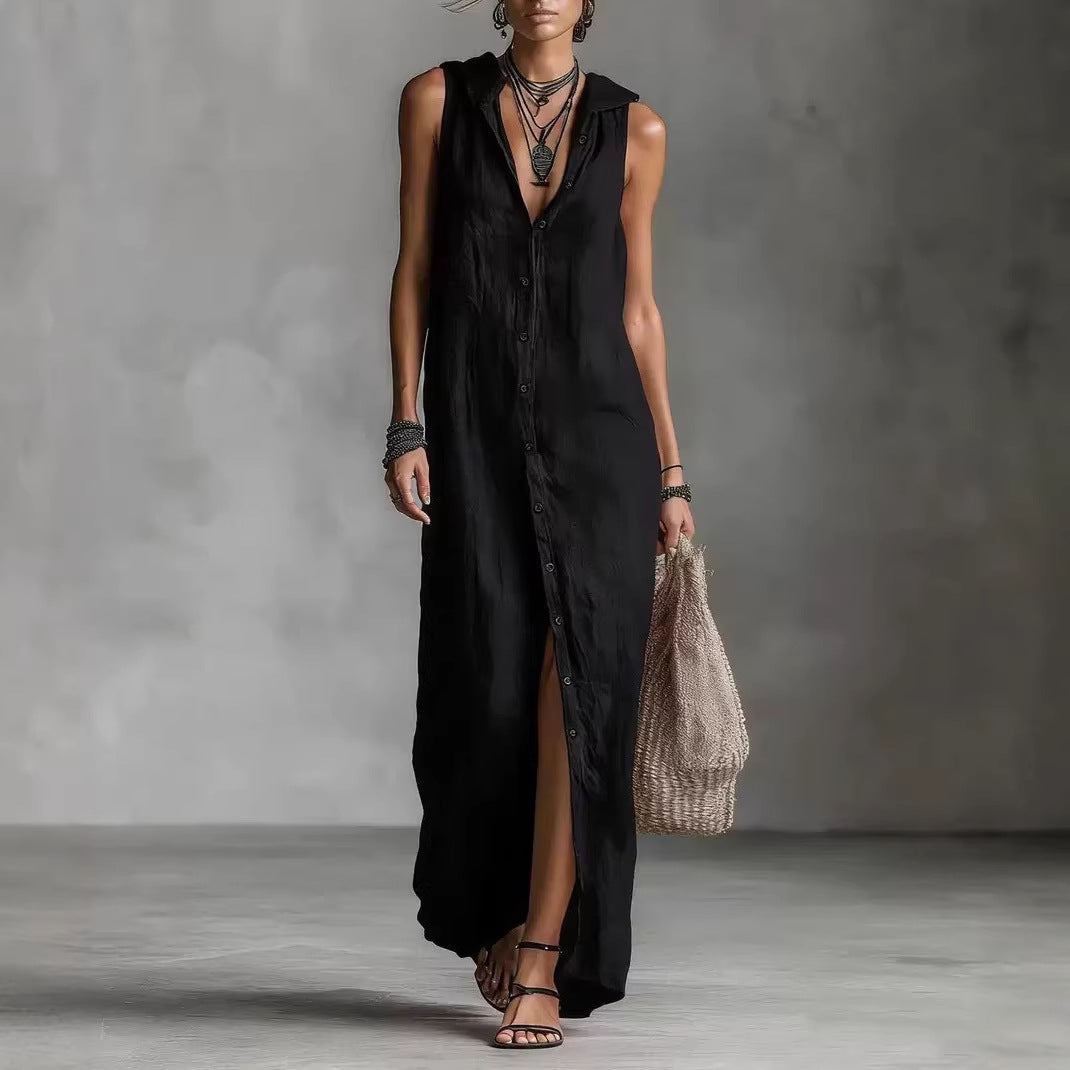 Woman wearing a black sleeveless dress with a high slit, holding a woven bag against a gray background.
