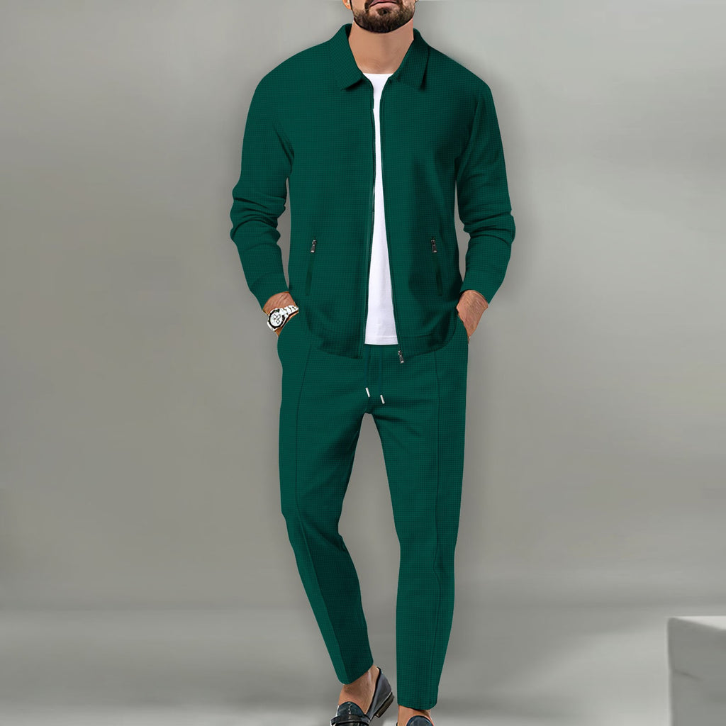 Man wearing a green tracksuit against a gray background