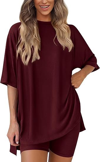 Woman wearing a burgundy oversized t-shirt and shorts set on a white background