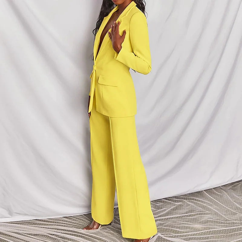 Person wearing a bright yellow suit against a plain background
