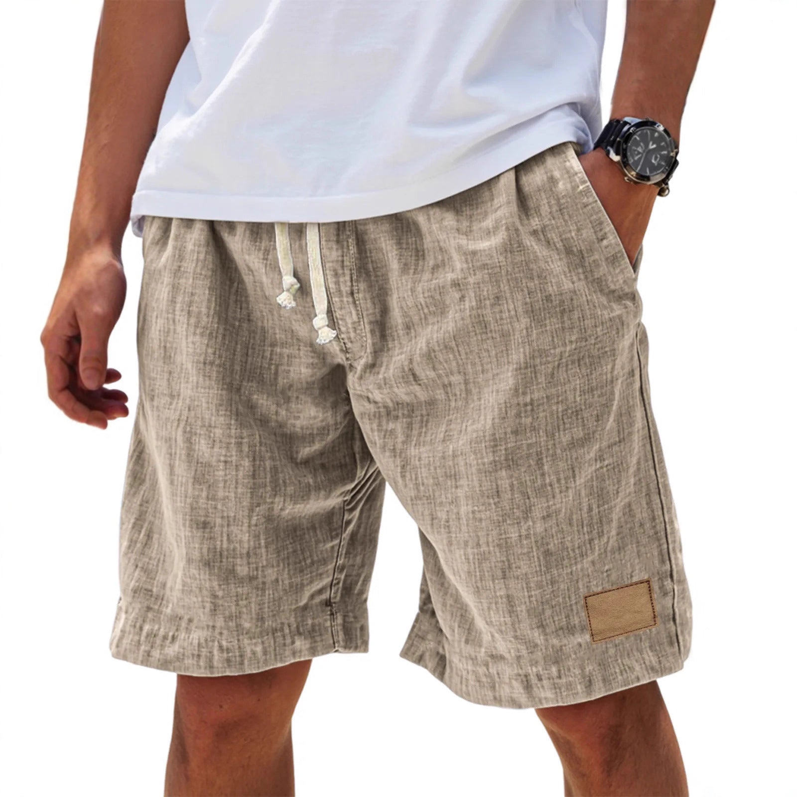 Beige shorts worn by a person on a white background