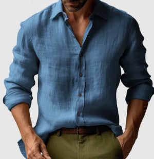 Man wearing a blue shirt and green pants on a gray background