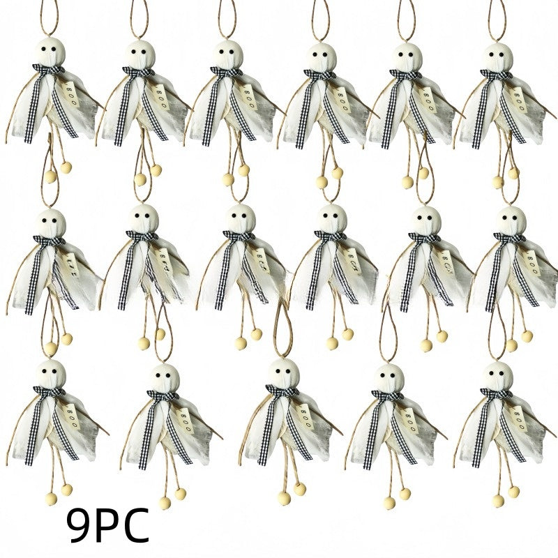 A set of 9 decorative hanging ornaments shaped like small ghosts, each with a white round head, black embroidered eyes and mouth, a sheer off-white cape, a black-and-white gingham ribbon bow, and dangling beige loops with small beige beads. The text '9PC' appears at the bottom left on a plain white background.