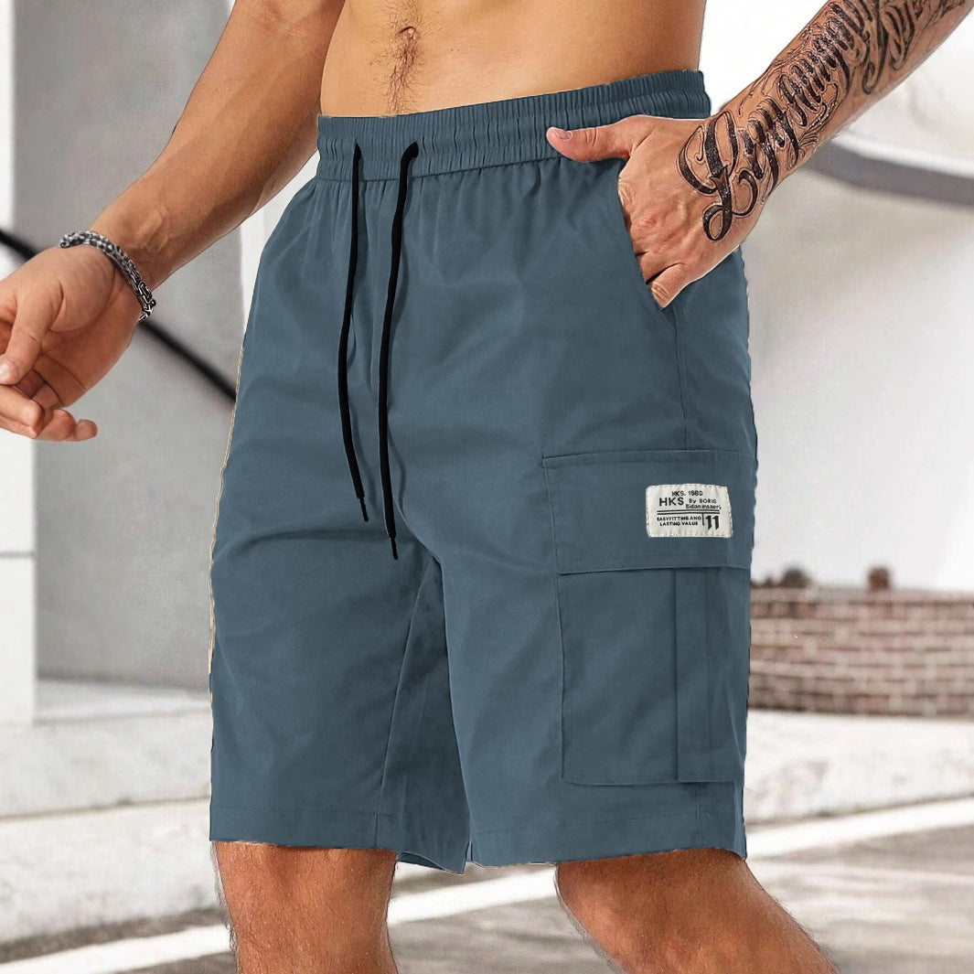 Blue cargo shorts with a brand logo on a blurred background
