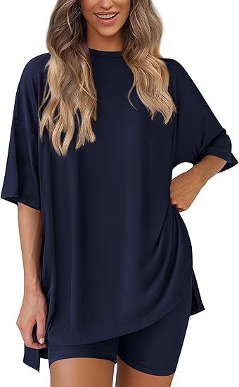 Woman wearing a navy blue oversized t-shirt and shorts set on a white background