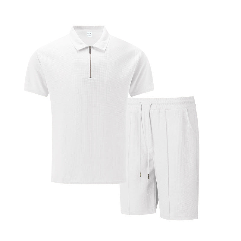 White polo shirt and shorts set on a white background