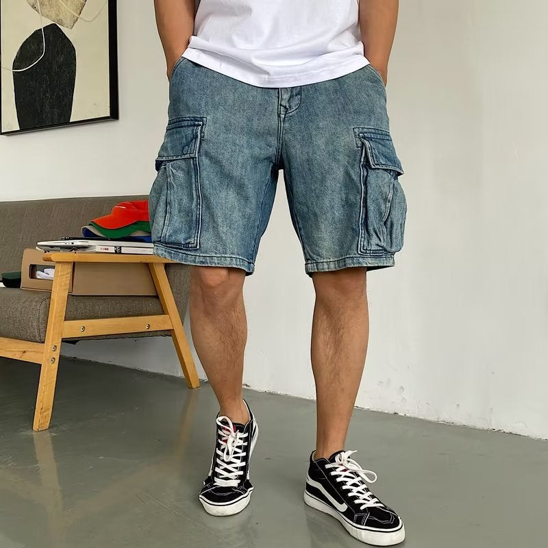 Person wearing blue cargo shorts and black sneakers in a minimal indoor setting