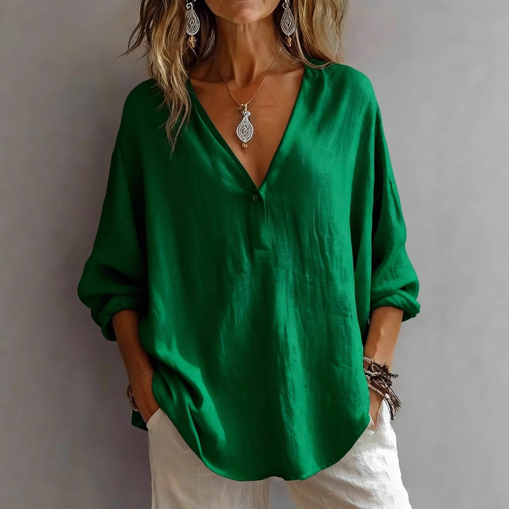 Person wearing a green blouse with a plain background