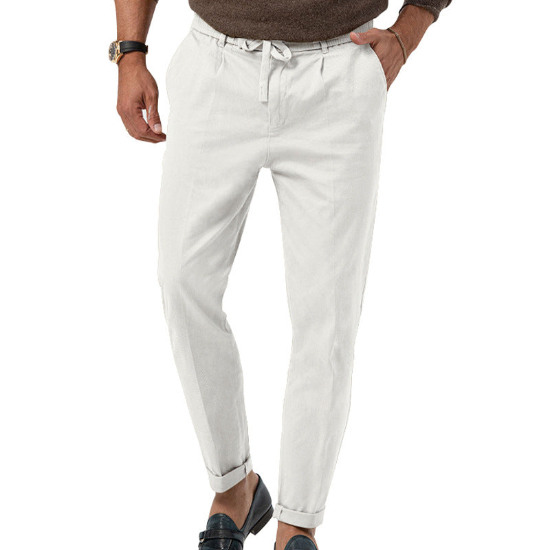 White pants worn by a person on a white background