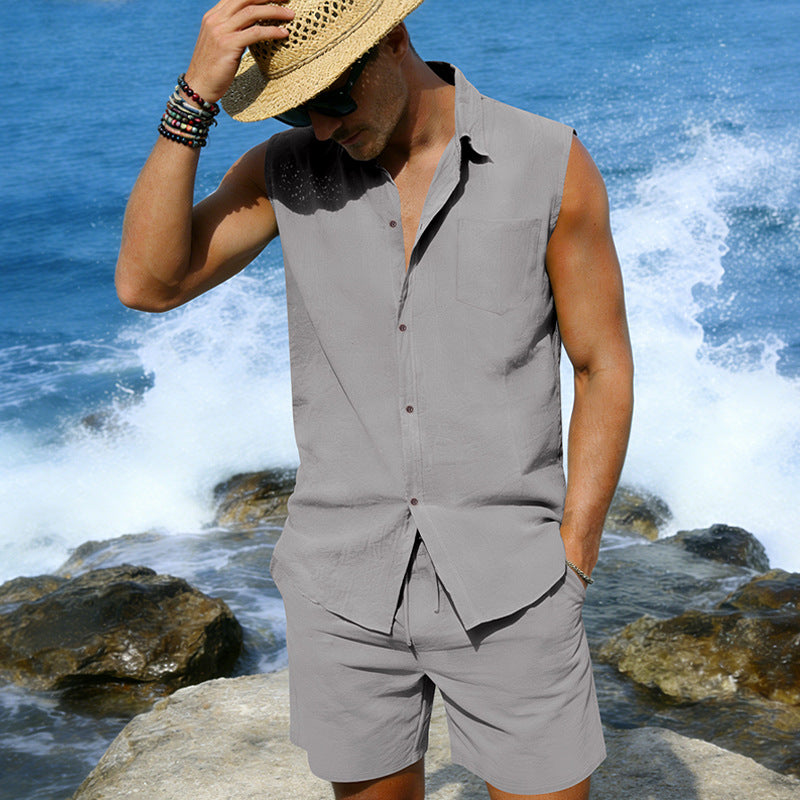 Man wearing a sleeveless shirt and shorts with a straw hat against a coastal background.