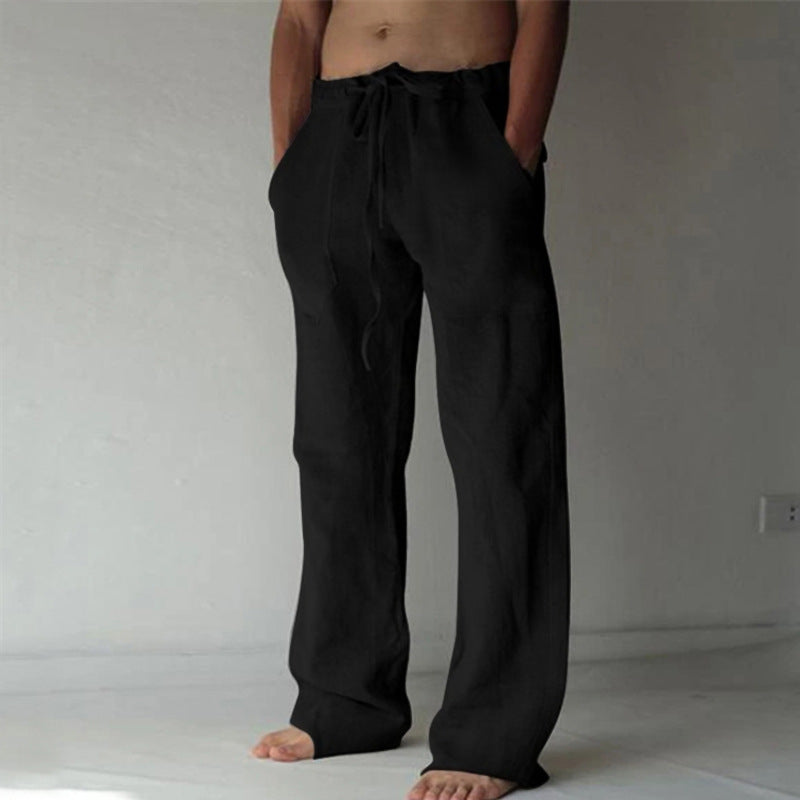 Person wearing black pants against a plain background