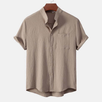 Beige short-sleeve shirt on a hanger against a white background