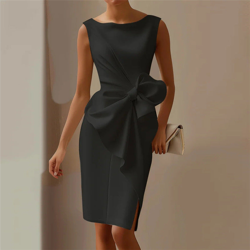 Black dress with a large bow detail on a neutral background