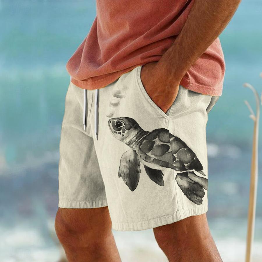 Person wearing shorts with a turtle design on a beach