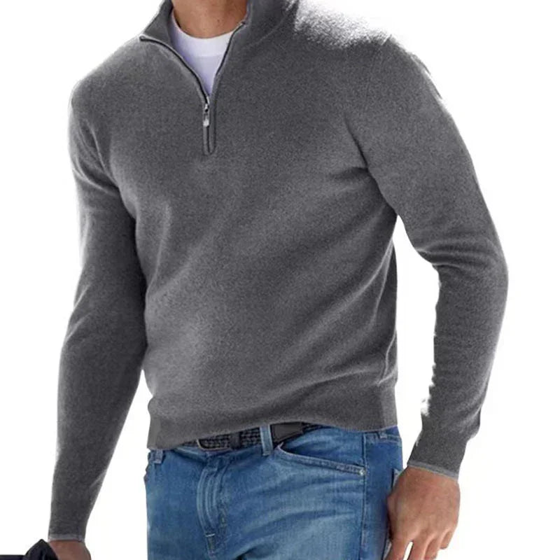 Gray half-zip sweater worn by a person on a white background