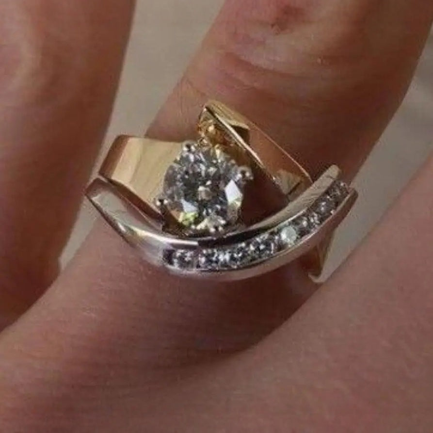 Gold ring with a diamond on a finger