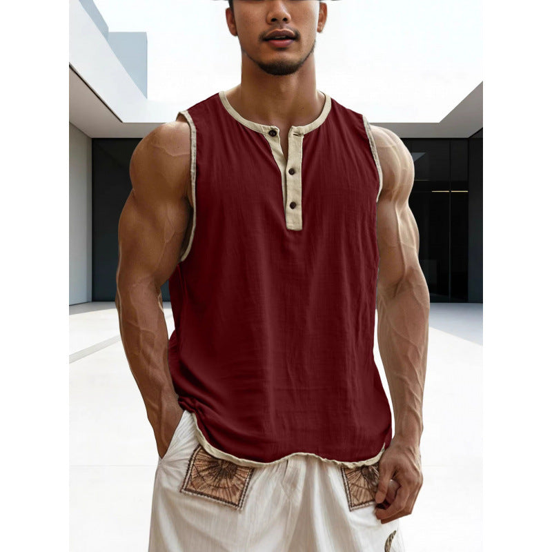 Man wearing a red sleeveless shirt with beige trim in an indoor setting