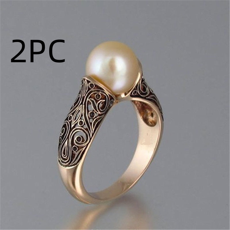 Gold ring with a pearl on a gray background