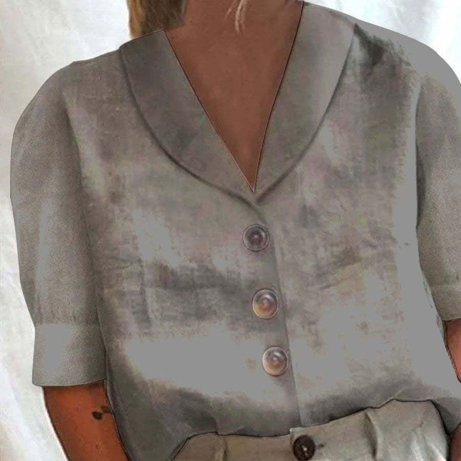 A close-up of a person wearing a short-sleeve V-neck top with three front buttons, shown against a light neutral background.