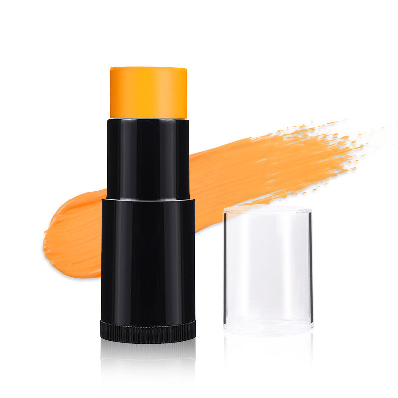 Black makeup stick with orange cap on a white background