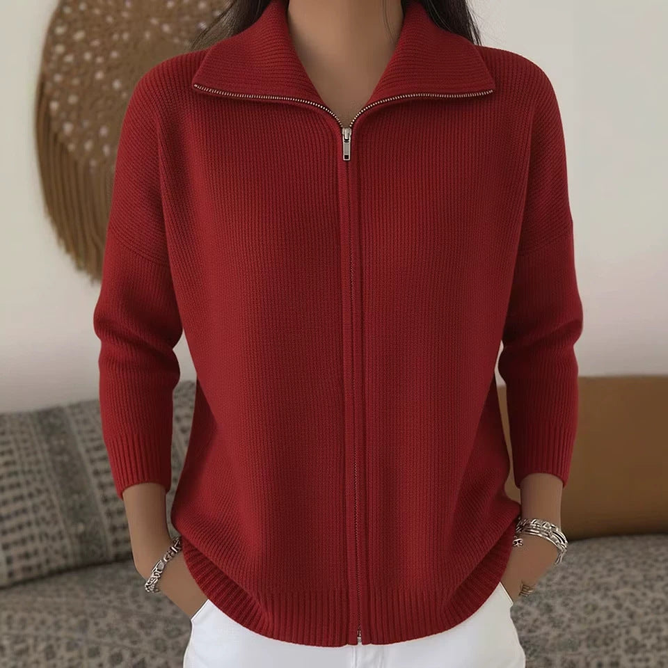 Red zip-up sweater worn by a person with a blurred background