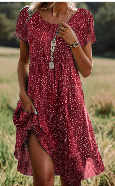 Woman wearing a red polka dot dress in a natural setting