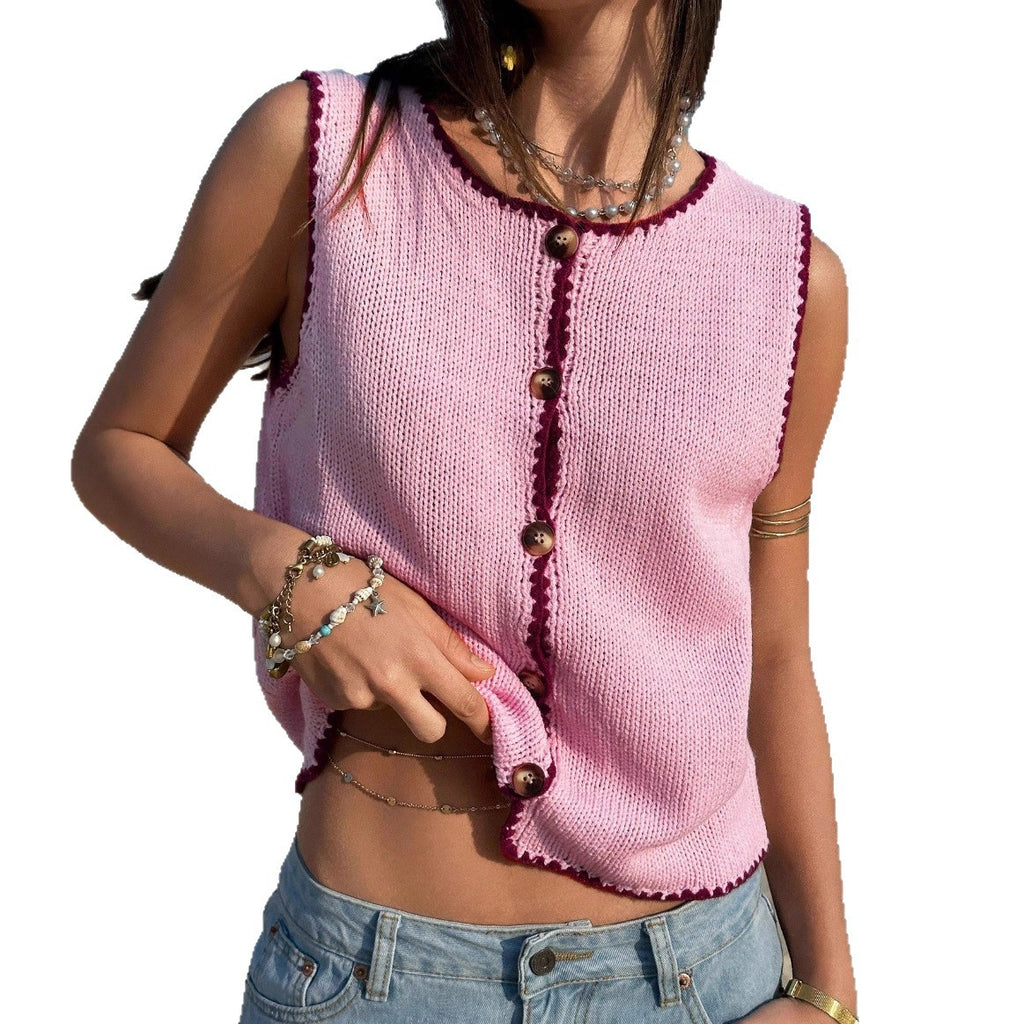 Person wearing a pink knitted vest with button details on a white background