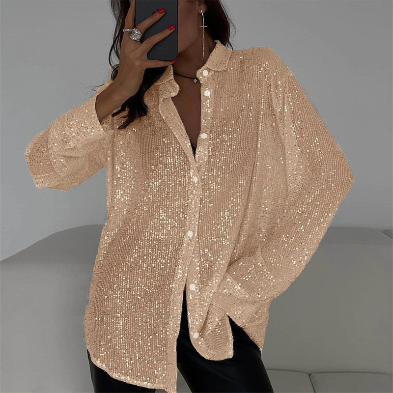 Person wearing a sparkly beige cardigan against a neutral background